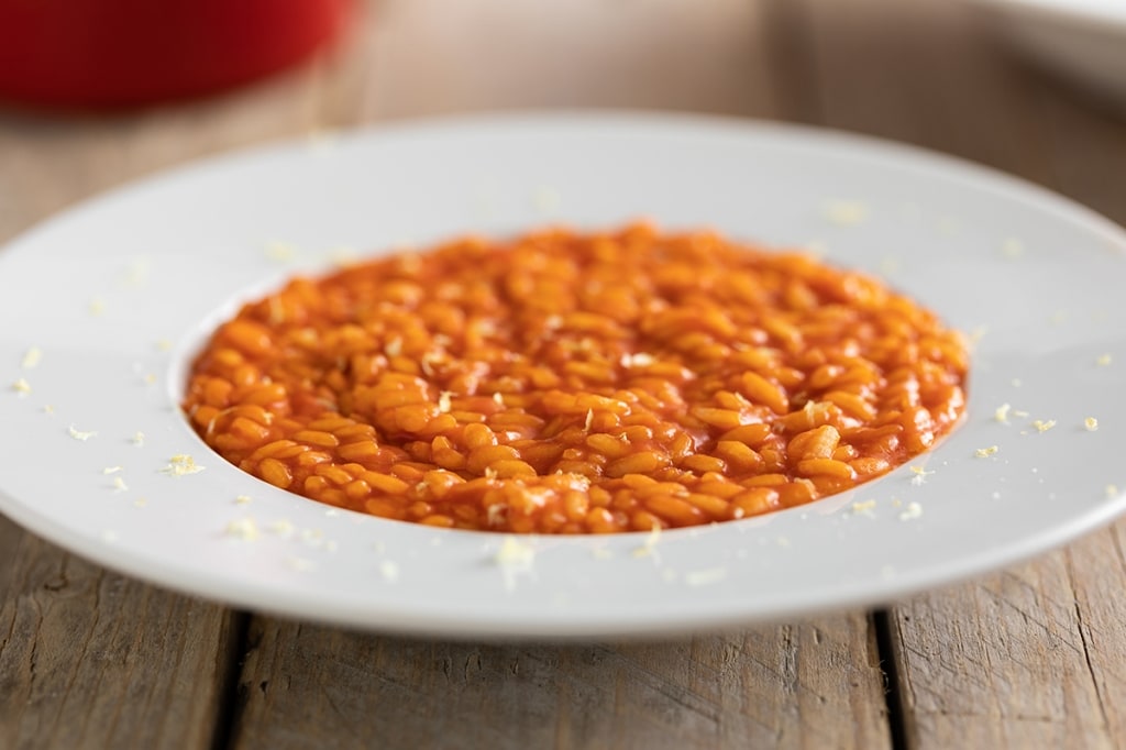 Risotto con fiocchi di latte e concentrato di pomodoro